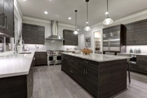 Kitchen with dark grey cabinets and marbled white/grey countertops