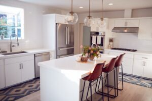 Modern kitchen with center island and white walls, cabinets, and countertops